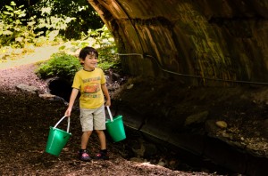 A member of the NW Nature Playgroup brings water from the Klingle Stream (Photo by Jamie Davis Smith)